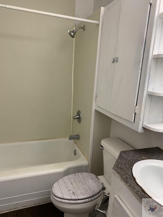 full bathroom with bathing tub / shower combination, toilet, and vanity