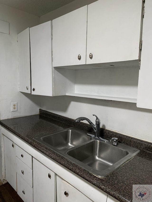 kitchen with sink and white cabinetry