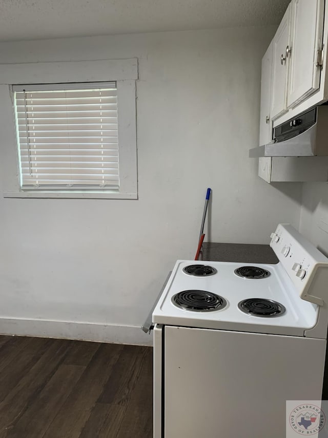 kitchen featuring dark wood-type flooring, electric stove, and white cabinetry