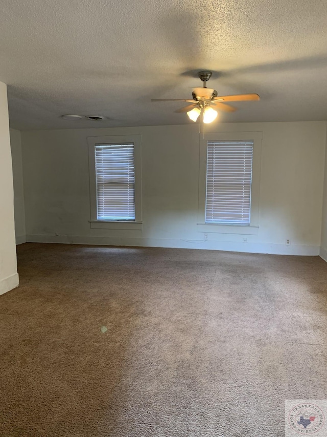 spare room with carpet floors, a textured ceiling, and ceiling fan