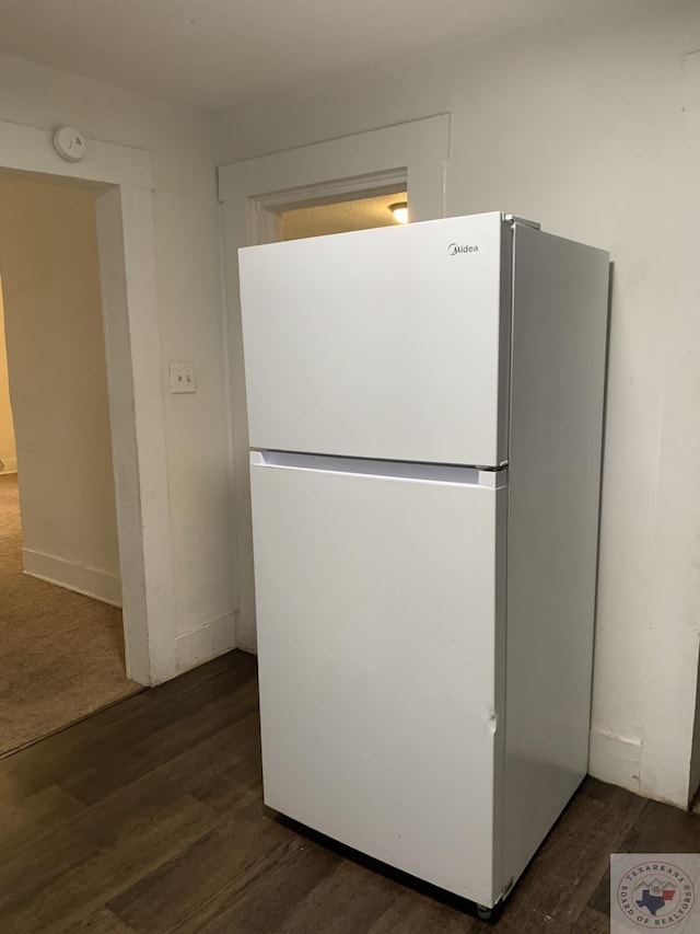 kitchen with dark wood-type flooring and white fridge