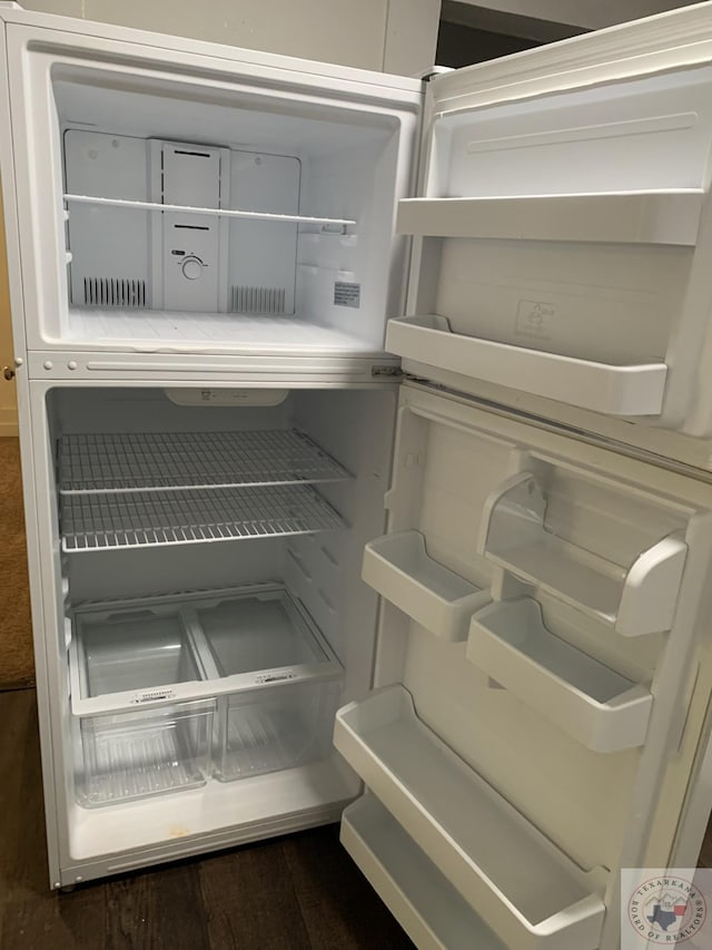 interior details featuring refrigerator and dark hardwood / wood-style floors