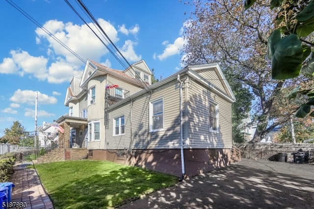 view of property exterior featuring a lawn