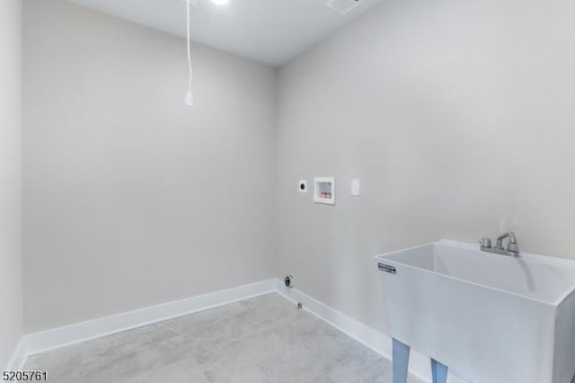 laundry area with hookup for a washing machine, laundry area, a sink, and baseboards