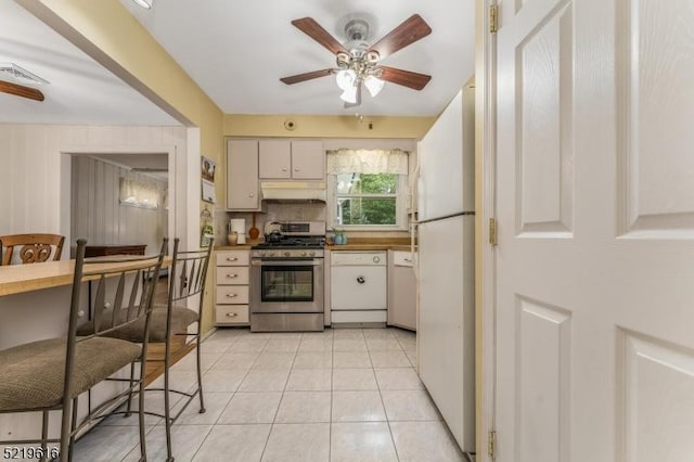 740 Mountain Ave, Bridgewater Twp, NJ 08805 - kitchen featuring stainless steel gas range oven, freestanding refrigerator, ceiling fan, light tile patterned floors, and under cabinet range hood