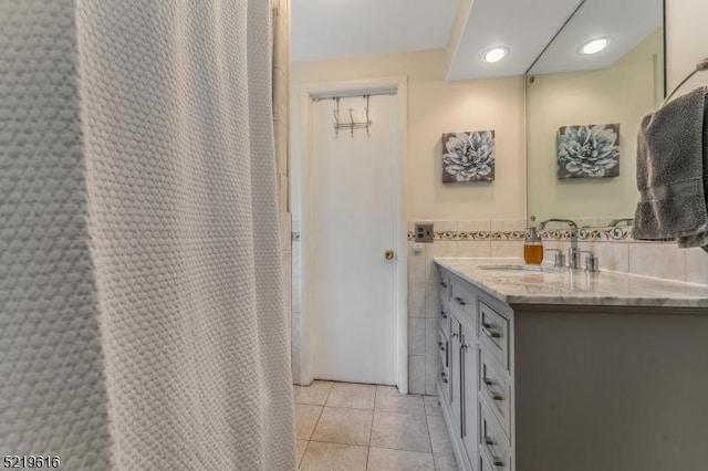 740 Mountain Ave, Bridgewater Twp, NJ 08805 - bathroom featuring double vanity, tile patterned floors, tile walls, and a wainscoted wall