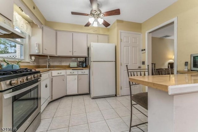740 Mountain Ave, Bridgewater Twp, NJ 08805 - kitchen with freestanding refrigerator, stainless steel range with gas cooktop, ceiling fan, a kitchen bar, and white cabinets