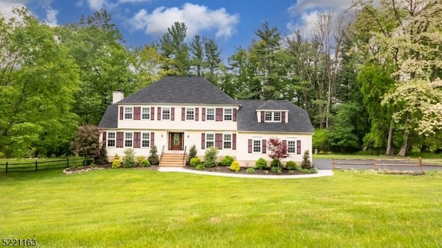 18 Cider Mill Ln, Washington Twp, NJ 07865 - view of front facade with a chimney, view of scattered trees, and roof with shingles