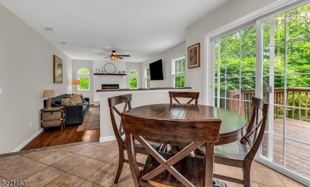 18 Cider Mill Ln, Washington Twp, NJ 07865 - dining room featuring healthy amount of natural light, a ceiling fan, a fireplace, and light tile patterned flooring