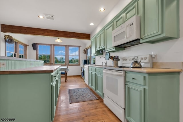 kitchen with beam ceiling, light hardwood / wood-style floors, white appliances, and green cabinetry