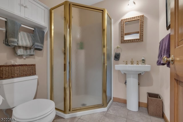 bathroom featuring toilet, tile flooring, and an enclosed shower