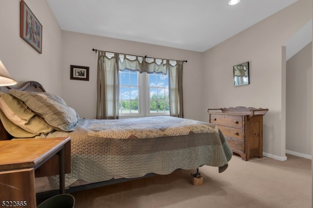 bedroom featuring light colored carpet