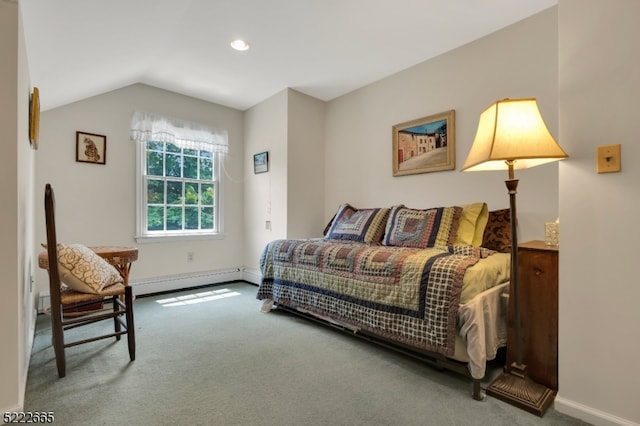 carpeted bedroom featuring a baseboard heating unit and vaulted ceiling