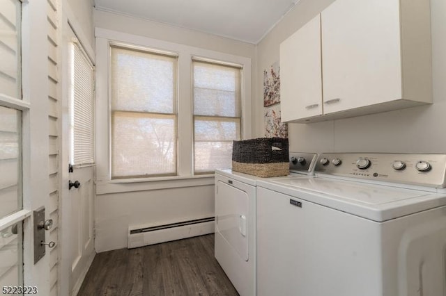 clothes washing area with washer and clothes dryer, baseboard heating, cabinet space, and dark wood finished floors