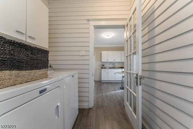 laundry area with a sink, dark wood finished floors, separate washer and dryer, crown molding, and laundry area