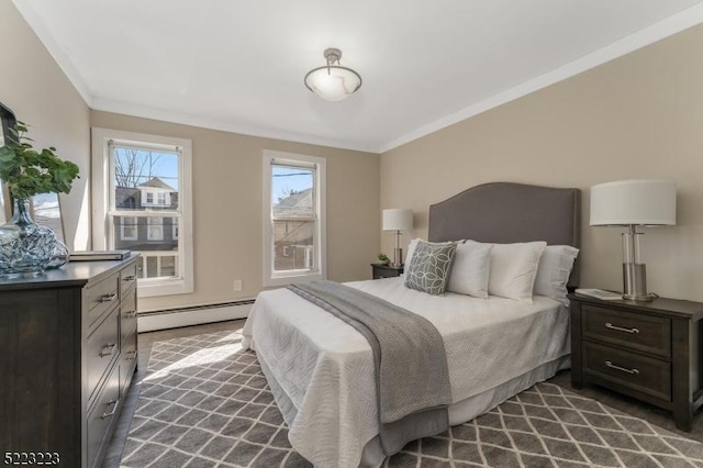 bedroom with crown molding and baseboard heating