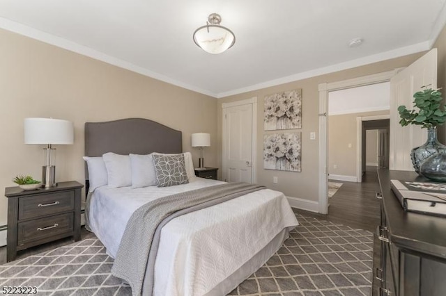 bedroom with a closet, baseboards, dark wood-type flooring, and crown molding