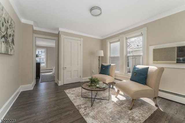 living area with a baseboard heating unit, baseboards, dark wood finished floors, and ornamental molding