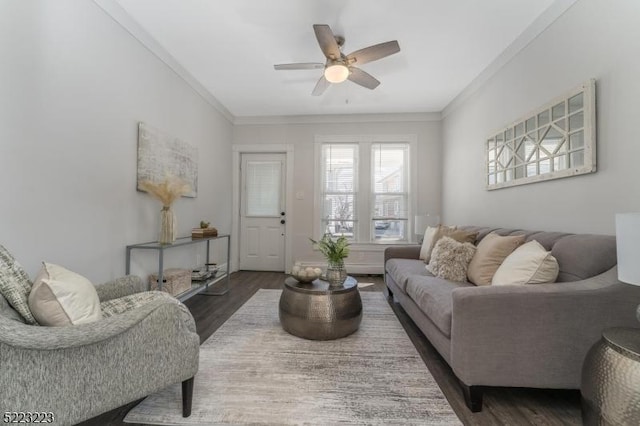 living room with crown molding, ceiling fan, and wood finished floors