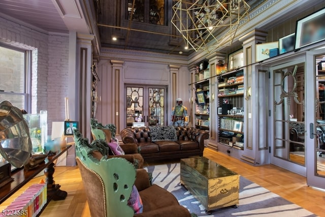 living area featuring light parquet floors, crown molding, and french doors