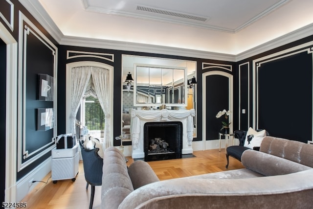 living room featuring crown molding and a tray ceiling