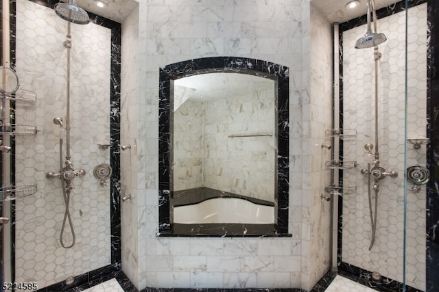 bathroom with tile walls, a tile shower, and tile floors