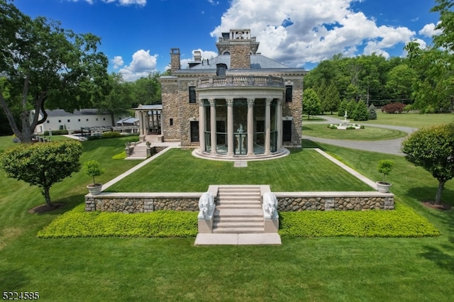 rear view of property with a lawn