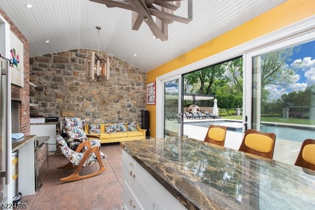 sunroom / solarium featuring lofted ceiling, ceiling fan, and plenty of natural light