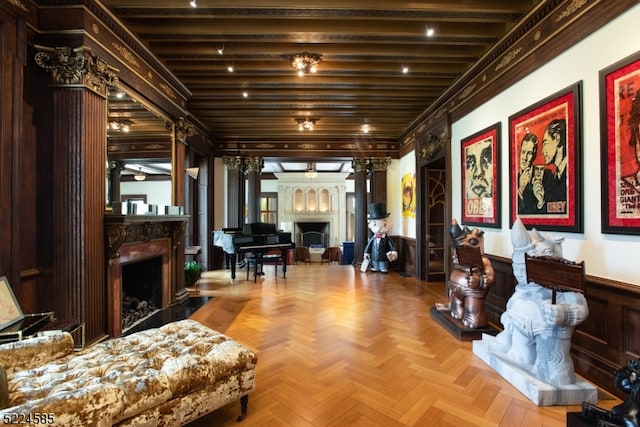 interior space featuring light parquet flooring, beam ceiling, and decorative columns