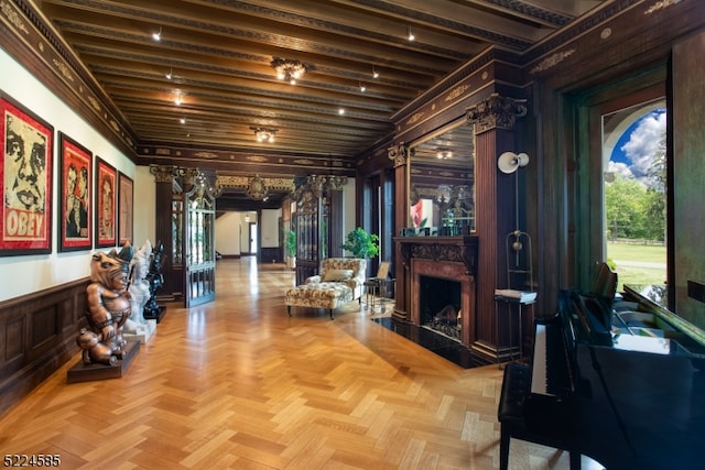 interior space featuring light parquet flooring, beam ceiling, and a premium fireplace