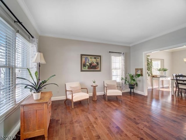 sitting room with crown molding, wood finished floors, and baseboards