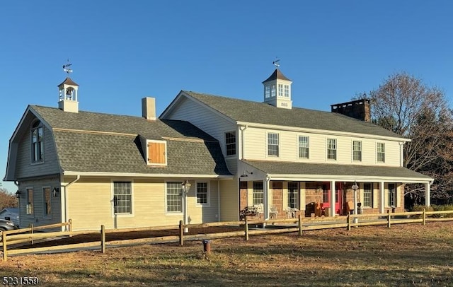 back of property with covered porch