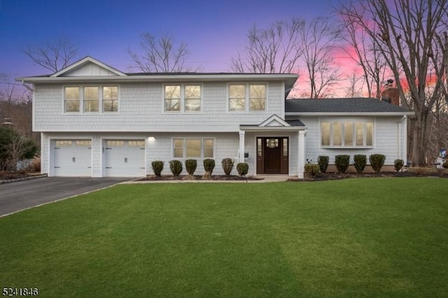 view of front of house with a lawn and a garage