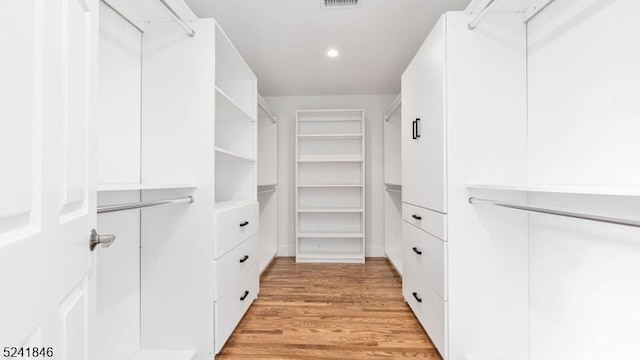 spacious closet featuring light hardwood / wood-style floors