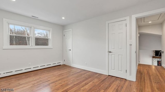 interior space featuring hardwood / wood-style floors and a baseboard heating unit