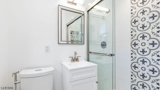 bathroom featuring vanity, toilet, and walk in shower