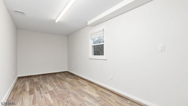 spare room with light wood-type flooring