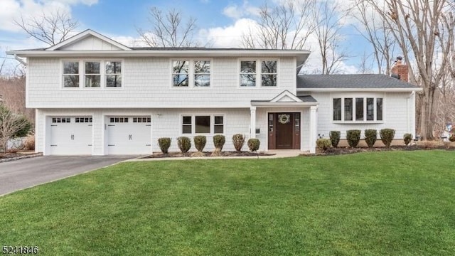 view of front of house featuring a garage and a front yard