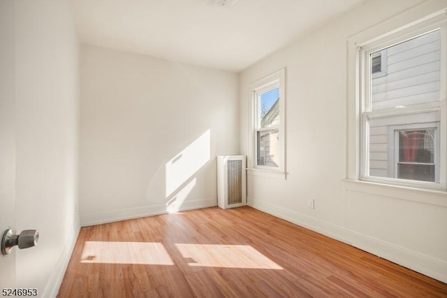 additional living space with baseboards, visible vents, and wood finished floors