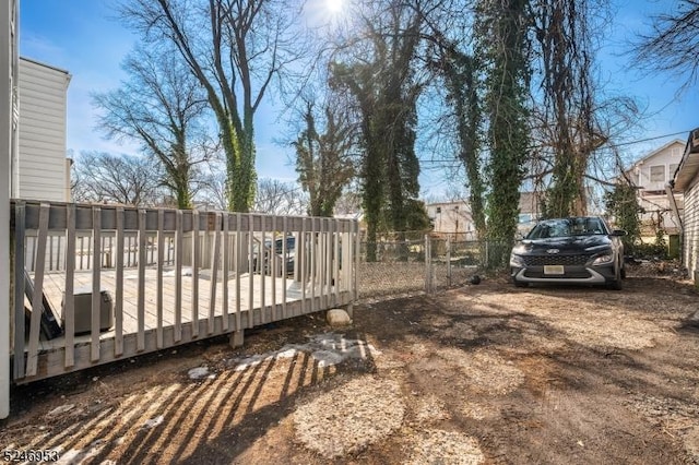 view of yard featuring fence and a wooden deck