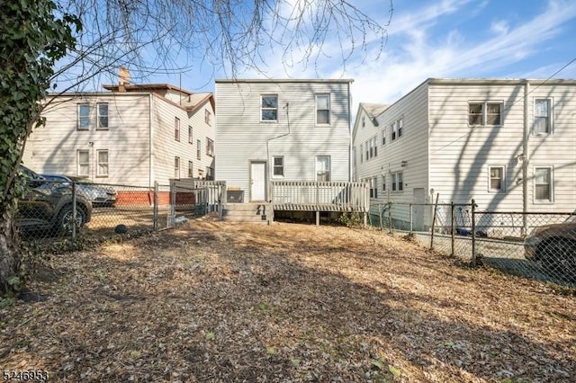 back of property featuring a fenced backyard and a wooden deck