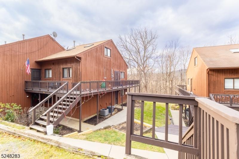 wooden terrace featuring cooling unit