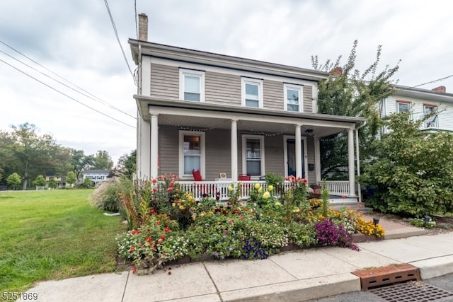 view of front facade featuring a front yard and a porch