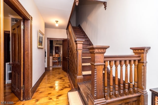 stairs with hardwood / wood-style floors