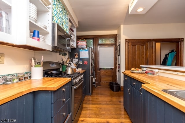 kitchen featuring black gas range, blue cabinets, wood counters, and hardwood / wood-style flooring