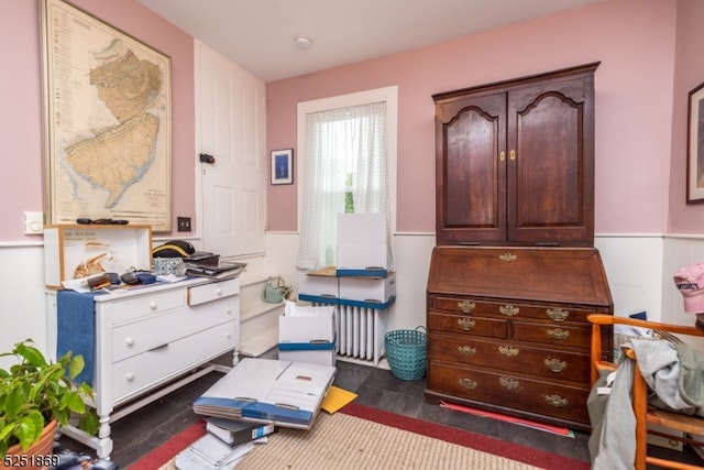 bedroom with dark hardwood / wood-style flooring and radiator