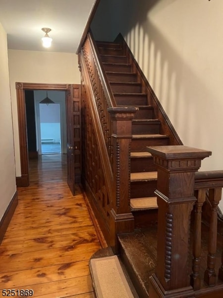 staircase featuring dark hardwood / wood-style flooring