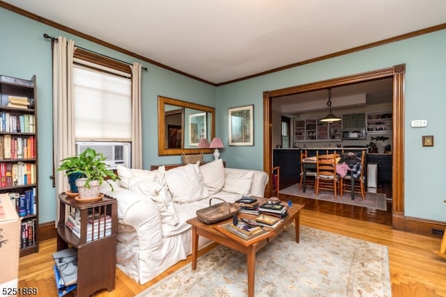 living room with crown molding and light hardwood / wood-style floors