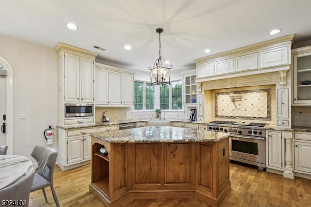30 Clairvaux Ct, Bernards Twp, NJ 07920 - kitchen with stainless steel appliances, a center island, a sink, tasteful backsplash, and light wood finished floors