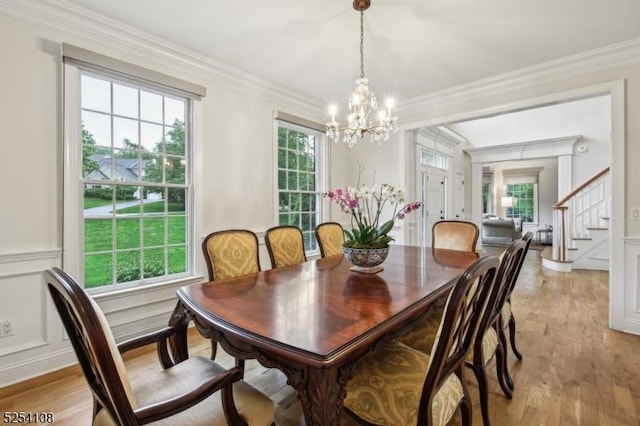 30 Clairvaux Ct, Bernards Twp, NJ 07920 - dining space featuring a chandelier, stairway, ornamental molding, light wood-style floors, and wainscoting